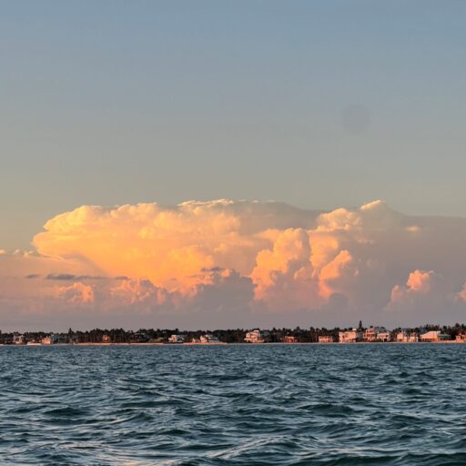 A view of the ocean with a sky filled with clouds.