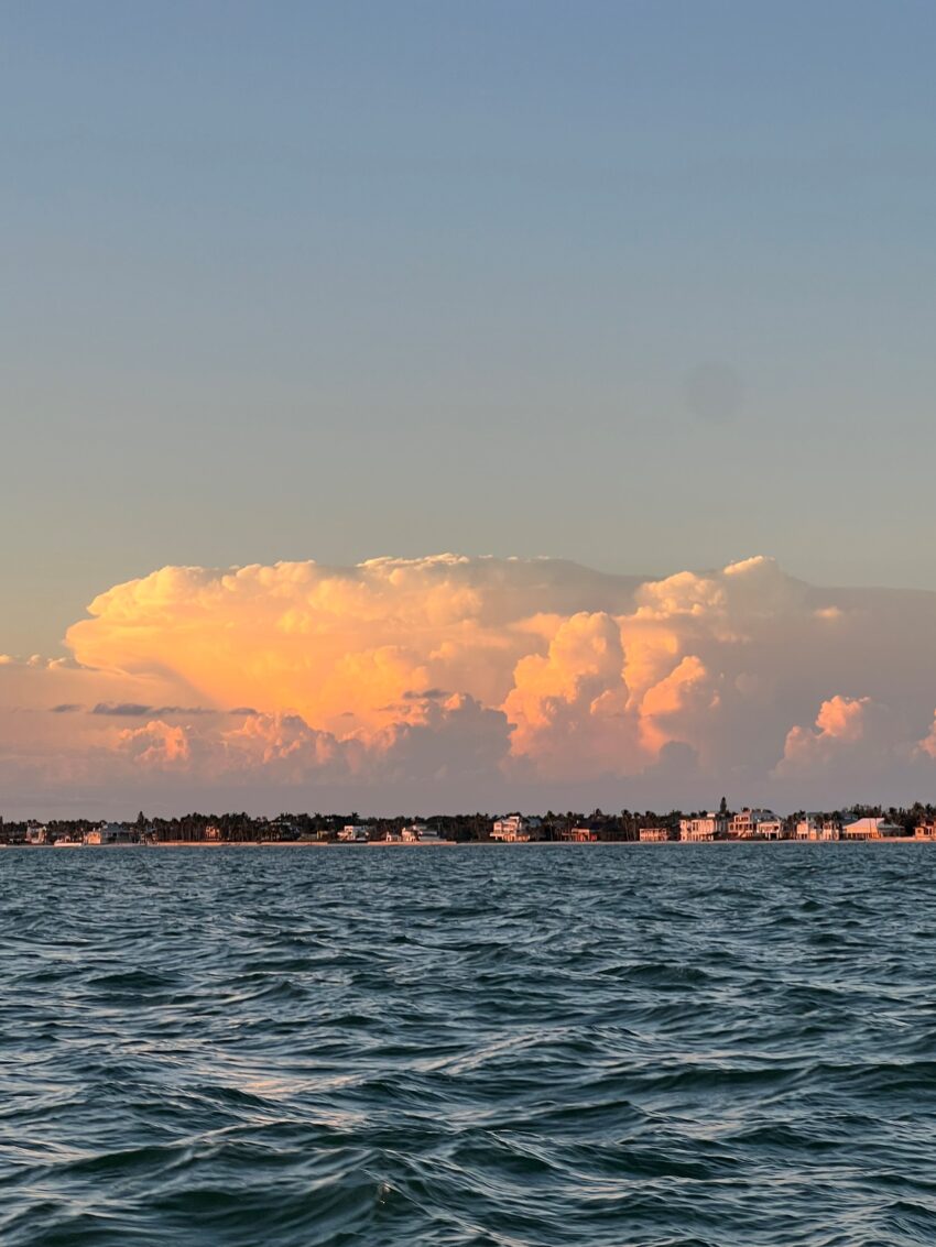 A view of the ocean with clouds in the sky.